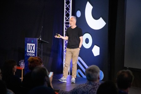 Matt Webb on stage at UX London, regaling the audience.