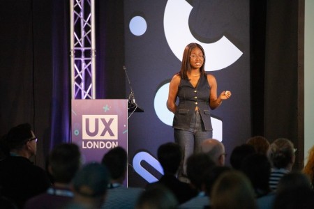 Tshili Nobu speaking on stage at UX London.