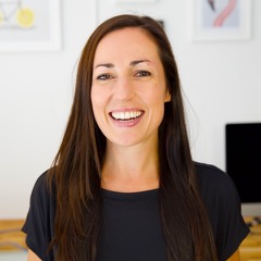 A smiling woman with long dark straight hair wearing a dark T-shirt.